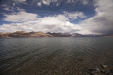 beautiful blue lake with mountains in the back