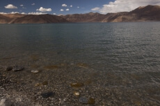 beautiful blue lake with mountains in the back