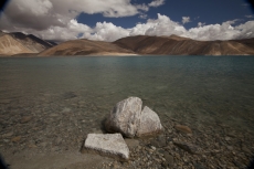 beautiful blue lake with mountains in the back