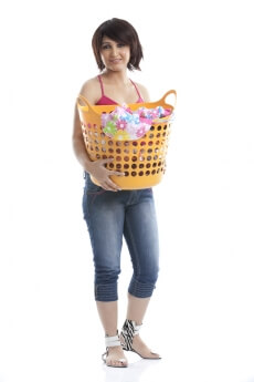 woman holding a laundry basket against white background