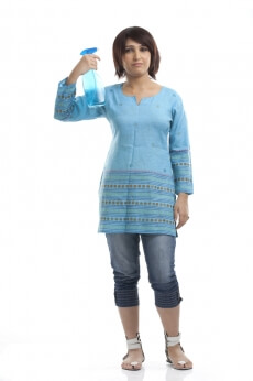 a woman with short hair carrying a cleaning product