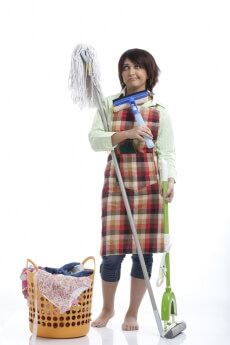 woman standing with tired look after cleaning the house