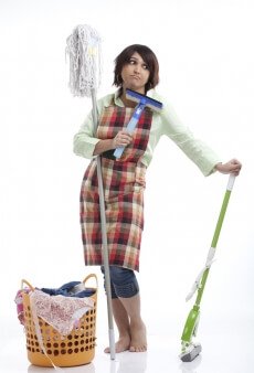 woman standing with tired look after cleaning the house