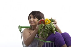 woman with a bunch of healty food in a paper bag