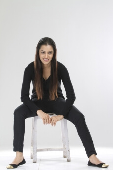 pretty girl sitting on a stool against white background
