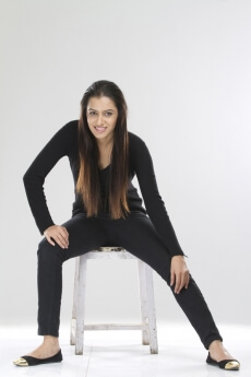 portrait of a stylish girl sitting on a stool against white background