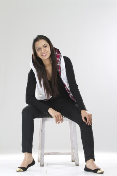 joyful pretty female sitting on a stool