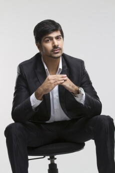 businessman sitting on office chair and posing for the camera 