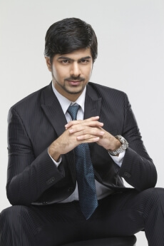 business executive posing while sitting on chair