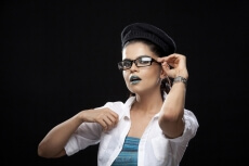 girl adjusting her glasses and posing