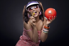 trendy model posing with red ball and lollipop
