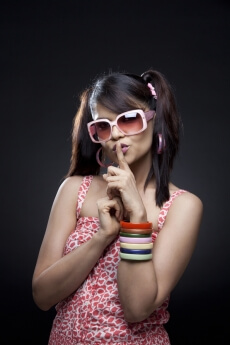 girl in casual wear telling to keep quiet