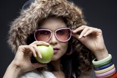 close-up on a model holding a green apple