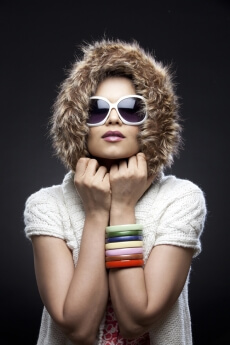 young girl in sunglasses and a fur hood