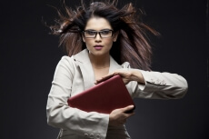 official woman with serious expressions holding a laptop