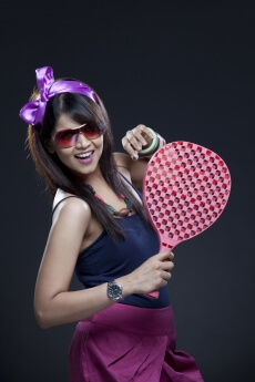 side pose of a teenager holding a racket