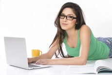 girl lying and posing with a silver laptop