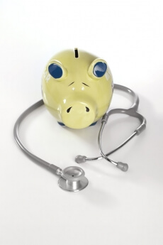 conceptual picture with piggy bank and stethoscope