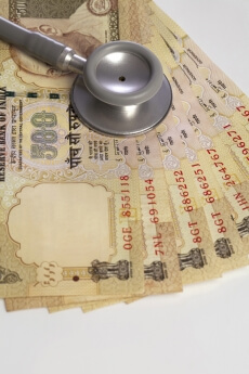 close up shot of rupee and stethoscope 