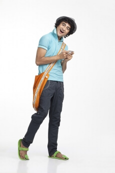 portrait of a boy texting on the mobile phone