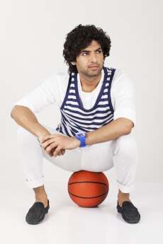 college boy sitting on basketball