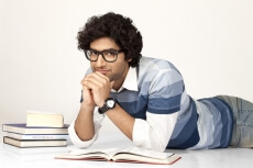 college boy studying and posing for the camera 