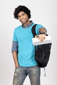 college boy with book pointing at camera 