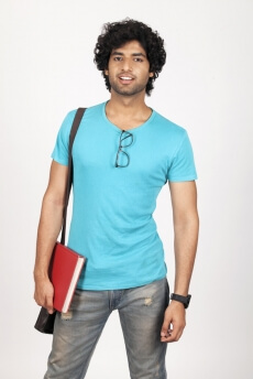 college guy holding a book and posing 
