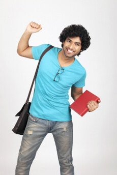 college boy holding book while posing for the camera