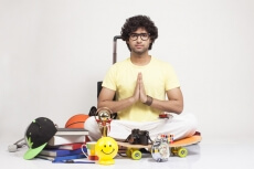 boy surrounded by things sitting and posing 