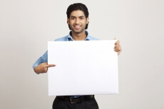 man pointing towards placard
