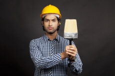 man posing with paint brush