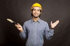 man shrugging with  paint brush in hand 