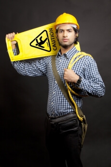 man carrying  caution stand looking at the camera 