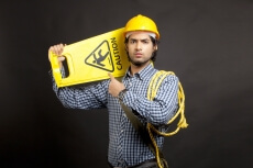man pointing at the caution board