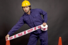 worker blocking way while looking at the camera