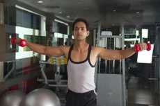 guy with determination working out in the gym