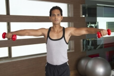 young guy exercising at the gym