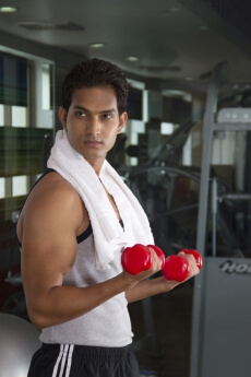 guy working out with red coloured dumbbells