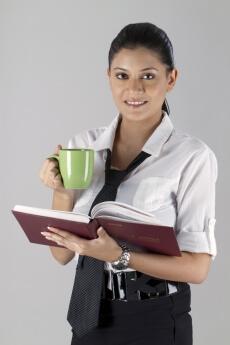 working woman posing with diary and coffee mug