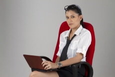 woman with specs posing while working