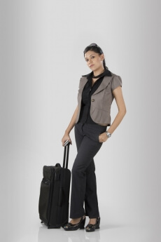 woman posing with a travelling bag
