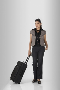woman posing with a suitcase