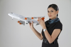 woman posing with an airplane