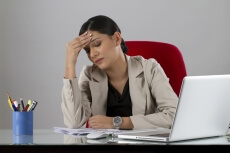 business woman feeling pain in her forehead