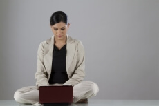 woman sitting down and looking at the laptop