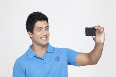 boy smiling while taking selfie 