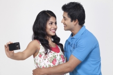 couple clicking while looking at each other 