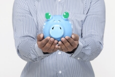 man holding piggy bank against a white background