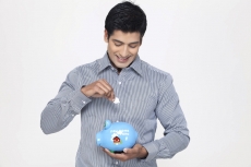 portrait of man with piggy bank